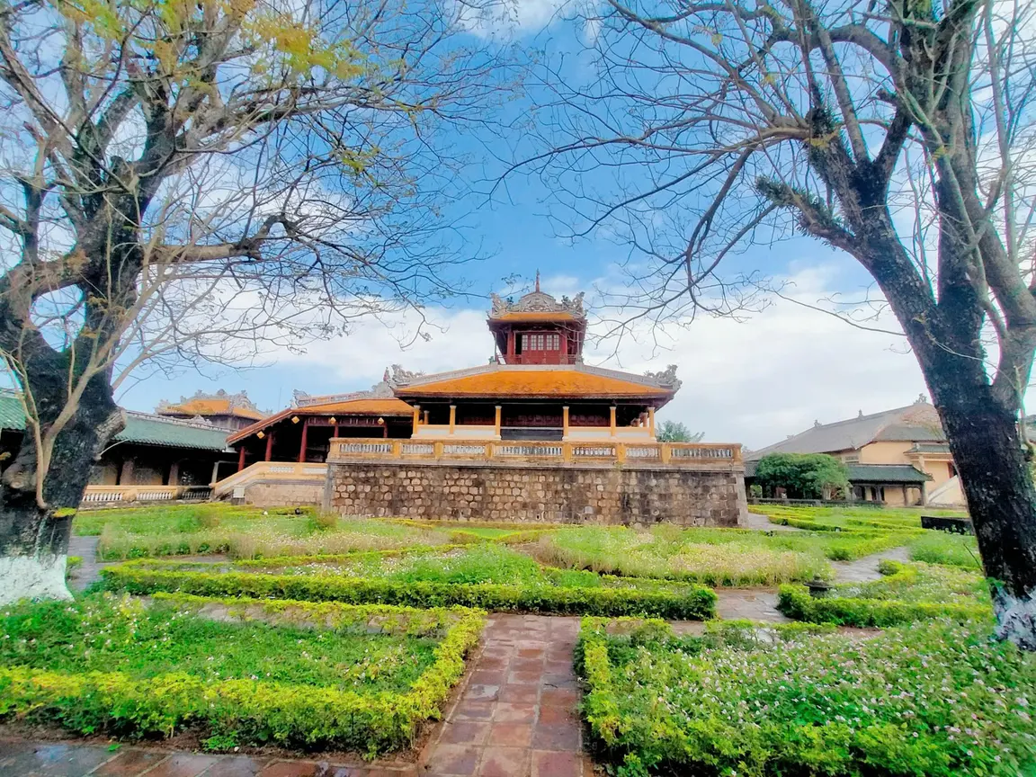 A garden path leading to an imperial building in Huế