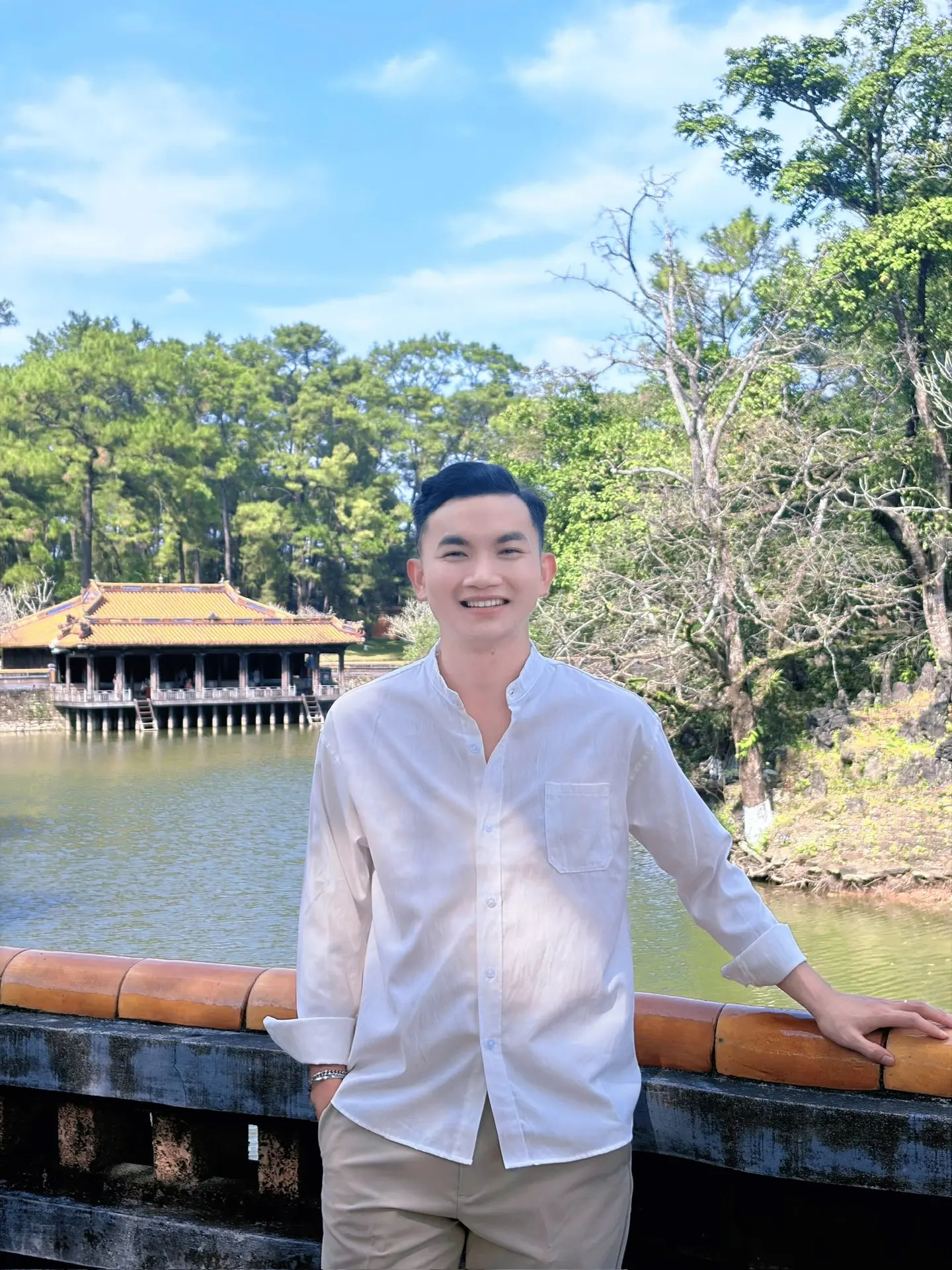 Ngọc Cường beside a pavilion lake in Huế