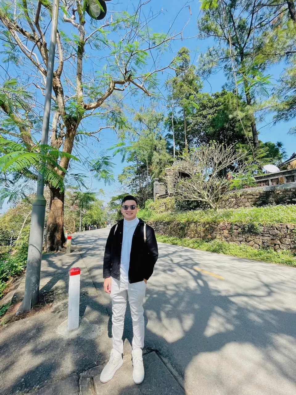 Ngọc Cường on a tree-lined street in Huế