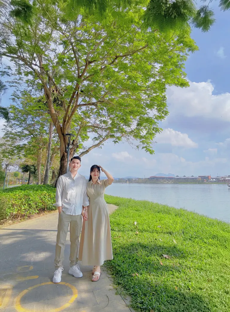 Ngọc Cường and a companion walking beside the river in Huế